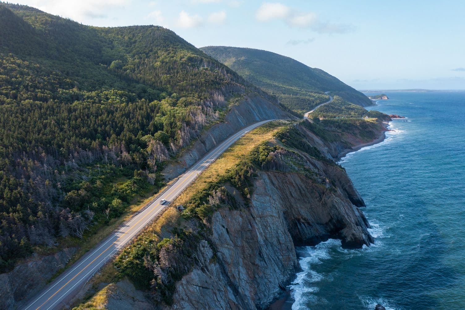 An aerial view of the Cabot Trail with the water in view.