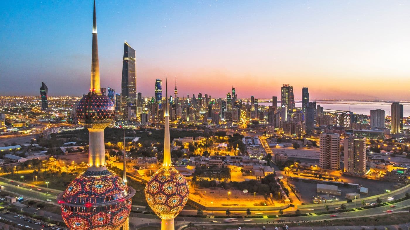 An aerial shot of the Kuwait Towers during sunset.