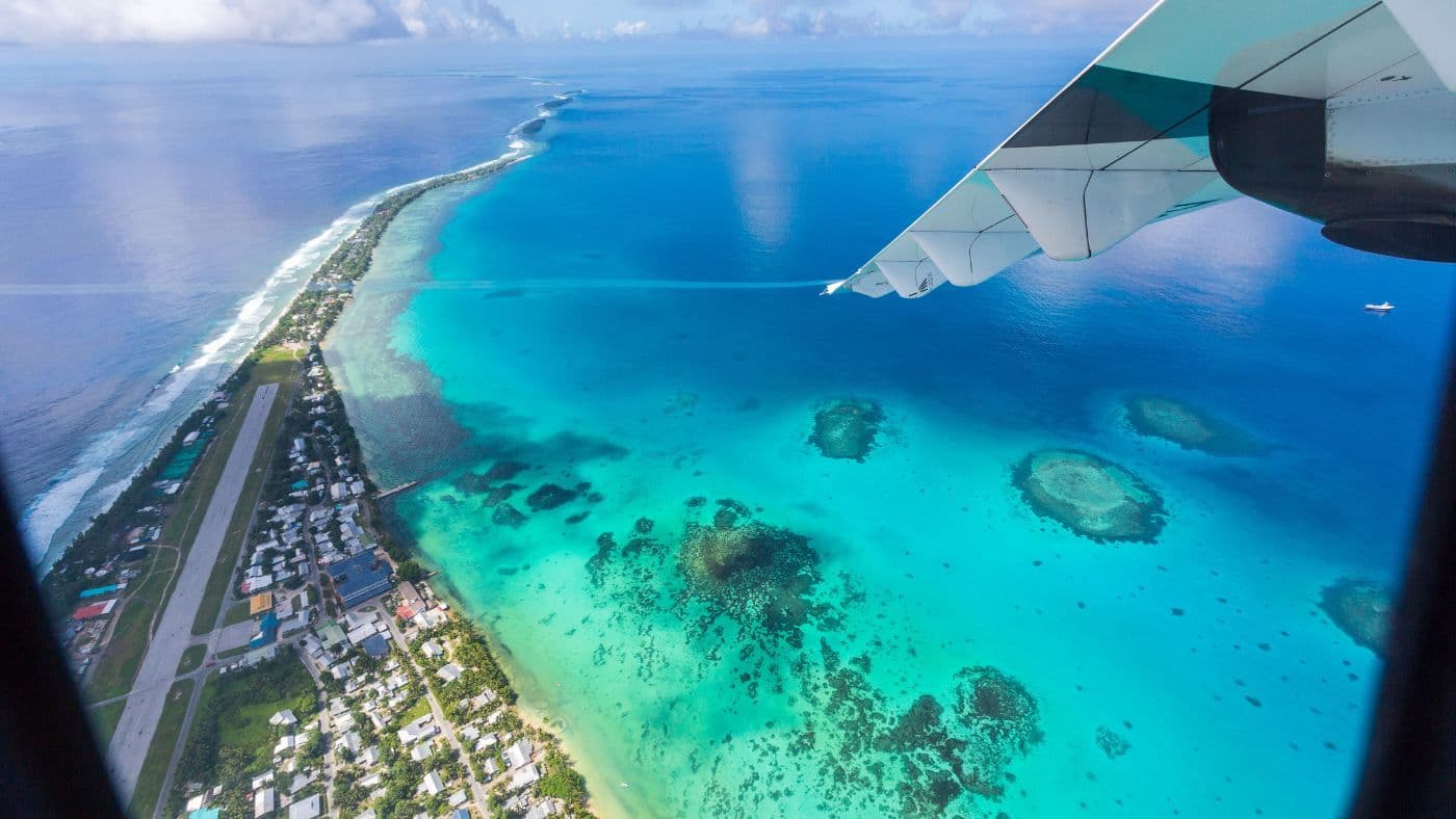 Tuvalu under the wing of an airplane. Vaiaku, Fongafale motu, Funafuti, Tuvalu